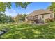 Lush green lawn highlights a fire pit, pool and the back of this inviting house at 790 Foxboro Dr, Avon, IN 46123