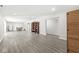 Spacious basement area with gray floors, ample lighting, room for entertaining, and access to storage at 790 Foxboro Dr, Avon, IN 46123