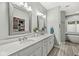 Elegant bathroom featuring dual sinks, quartz countertop, and walk-in closet access at 790 Foxboro Dr, Avon, IN 46123
