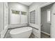 Relaxing bathroom boasting a soaking tub, mosaic tile accents, and natural light at 790 Foxboro Dr, Avon, IN 46123
