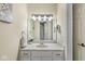 Bathroom features a single sink vanity with a decorative mirror, modern lighting, and a doorway to an adjacent room at 790 Foxboro Dr, Avon, IN 46123
