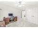 Spacious bedroom with a ceiling fan, neutral carpet, a large desk, and access to a hallway with additional closets at 790 Foxboro Dr, Avon, IN 46123