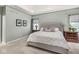Comfortable bedroom showcasing a tufted headboard, neutral tones, and soft carpet at 790 Foxboro Dr, Avon, IN 46123