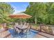 A cozy outdoor dining area on the deck offers a relaxing retreat with views of the lush trees and the property beyond at 790 Foxboro Dr, Avon, IN 46123