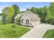 Charming two-story house with a well-manicured lawn, mature trees, and a spacious driveway leading to a two-car garage at 790 Foxboro Dr, Avon, IN 46123