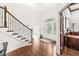 Inviting foyer with hardwood floors, decorative front door, and staircase at 790 Foxboro Dr, Avon, IN 46123