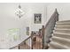 Elegant foyer features a chandelier, staircase with iron spindles, and glass front door at 790 Foxboro Dr, Avon, IN 46123