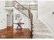 Stunning foyer with a curved staircase, wood floors, and iron railing at 790 Foxboro Dr, Avon, IN 46123