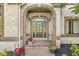 Charming front entrance with brick archway, decorative glass door, and colorful potted plants at 790 Foxboro Dr, Avon, IN 46123