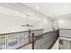 Bright second floor hallway with wood railing and iron spindles overlooking the living room at 790 Foxboro Dr, Avon, IN 46123