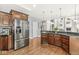 Open kitchen features dark wood cabinets, granite countertops, stainless steel appliances, and hardwood floors at 790 Foxboro Dr, Avon, IN 46123