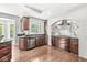 An open kitchen featuring dark wood cabinets, stainless steel appliances, and a unique white brick archway at 790 Foxboro Dr, Avon, IN 46123
