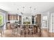 Wide angle of kitchen featuring dark wood cabinets, stainless steel appliances, granite countertops, and island with seating at 790 Foxboro Dr, Avon, IN 46123