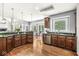 Spacious kitchen showcasing dark wood cabinets, granite countertops, stainless steel appliances, and hardwood floors at 790 Foxboro Dr, Avon, IN 46123