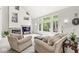 Cozy living room with a fireplace, large windows, and comfortable seating at 790 Foxboro Dr, Avon, IN 46123