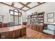 Well-appointed office with wood coffered ceiling, built-in bookcase, large window and wood floors at 790 Foxboro Dr, Avon, IN 46123