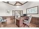 Spacious office with wood paneled walls, wood floors, glass panel doors, and adjacent stairway at 790 Foxboro Dr, Avon, IN 46123