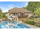 A refreshing pool sits in the backyard, complemented by a raised deck and a patio for relaxation and outdoor enjoyment at 790 Foxboro Dr, Avon, IN 46123