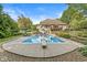 A sprawling pool with a diving board surrounded by landscaped grounds creates an inviting outdoor oasis for recreation and relaxation at 790 Foxboro Dr, Avon, IN 46123