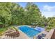 Sparkling backyard pool with surrounding greenery and lounge furniture provides a private retreat at 790 Foxboro Dr, Avon, IN 46123