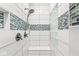 Modern shower showcasing white tile, mosaic accents, and glass block window at 790 Foxboro Dr, Avon, IN 46123