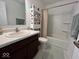 Clean bathroom with vanity, mirror, shower, and useful storage shelving at 808 Capricorn Dr, Franklin, IN 46131
