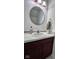 Bathroom vanity featuring a marble countertop, round mirror and modern fixtures at 808 Capricorn Dr, Franklin, IN 46131