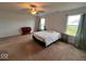 Spacious bedroom featuring neutral carpet, ceiling fan, and large windows allowing natural light at 808 Capricorn Dr, Franklin, IN 46131