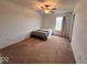 Bright bedroom featuring carpet, ceiling fan, and a window offering natural light at 808 Capricorn Dr, Franklin, IN 46131