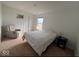 Cozy bedroom with neutral walls and carpet, comfy recliner, and large window for natural light at 808 Capricorn Dr, Franklin, IN 46131