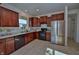 Well-lit kitchen with wooden cabinets, stainless steel refrigerator, and tiled floors at 808 Capricorn Dr, Franklin, IN 46131