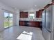 Bright kitchen with tile floors, stainless steel appliances, and a sliding glass door to the backyard at 808 Capricorn Dr, Franklin, IN 46131