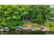 Aerial view of a lake house surrounded by mature trees, featuring a boat dock and lake access at 8434 S Christian Dr, Nineveh, IN 46164
