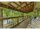 Enjoy lake views from this spacious covered deck with wooden railings and comfortable seating at 8434 S Christian Dr, Nineveh, IN 46164