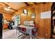 Cozy dining area featuring rustic wood paneling, perfect for enjoying meals with a view of the outdoors at 8434 S Christian Dr, Nineveh, IN 46164