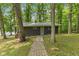 Charming cabin featuring a quaint brick path, surrounded by lush trees providing a private and serene setting at 8434 S Christian Dr, Nineveh, IN 46164