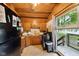Efficient kitchen with wood cabinets, essential appliances, and a view of the outdoors, offering practicality and charm at 8434 S Christian Dr, Nineveh, IN 46164