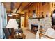 Inviting living room features a stone fireplace and rustic wood paneling, creating a cozy and warm ambiance at 8434 S Christian Dr, Nineveh, IN 46164