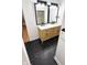 Modern bathroom with a double vanity, sleek fixtures, and marble-style tile flooring at 909 N Temple Ave, Indianapolis, IN 46201