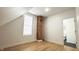 Spacious bedroom with natural light, hardwood floors, and a decorative brick element at 909 N Temple Ave, Indianapolis, IN 46201