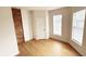Cozy bedroom with exposed brick wall and hardwood floors at 909 N Temple Ave, Indianapolis, IN 46201