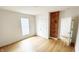 This bedroom features hardwood floors, an exposed brick wall, and ample natural light at 909 N Temple Ave, Indianapolis, IN 46201
