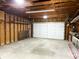 Spacious unfinished garage interior showing exposed rafters and a large garage door at 909 N Temple Ave, Indianapolis, IN 46201