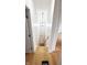Bright hallway with wood floors, lighting, and stairway with natural light at 909 N Temple Ave, Indianapolis, IN 46201
