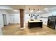 Open kitchen featuring a black kitchen island, stainless steel appliances, and white cabinets at 909 N Temple Ave, Indianapolis, IN 46201
