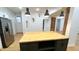 Spacious kitchen featuring stainless steel appliances and a dark kitchen island at 909 N Temple Ave, Indianapolis, IN 46201