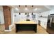 Kitchen with butcher block island, stainless steel appliances, and white cabinetry at 909 N Temple Ave, Indianapolis, IN 46201