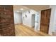 Cozy living room with hardwood floors and architectural details with a classic exposed brick column at 909 N Temple Ave, Indianapolis, IN 46201