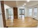 Bright living room with hardwood floors, vintage door and modern windows creates a warm atmosphere at 909 N Temple Ave, Indianapolis, IN 46201