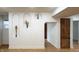 White living room with arched displays on the wall and a light brown door at 909 N Temple Ave, Indianapolis, IN 46201